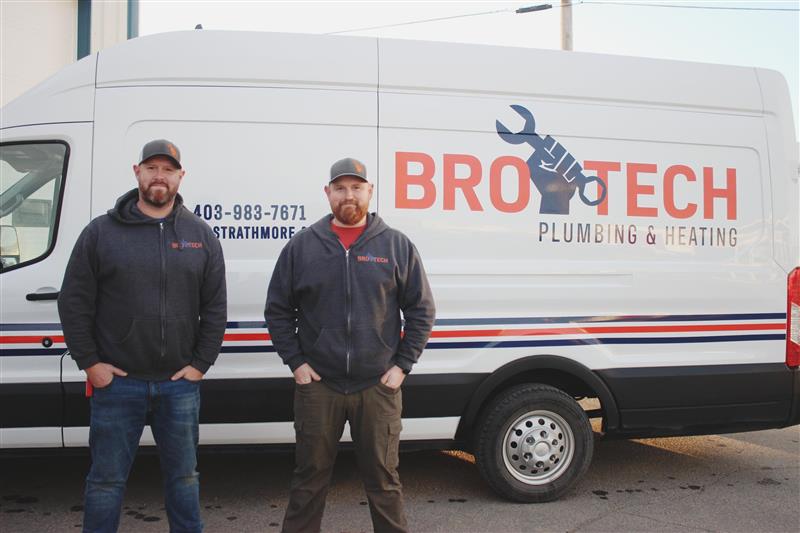Preston and Dylan standing in front of a Brotech van About Image